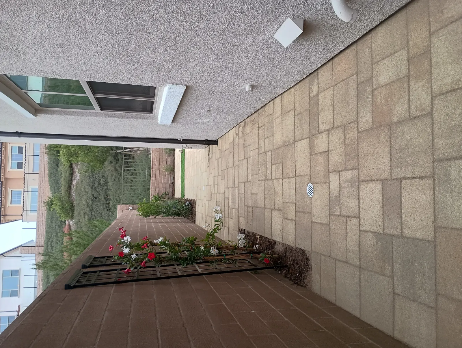 A tiled courtyard patio area shown in a vertical orientation format.